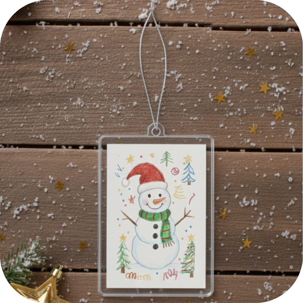 A Christmas tree decoration with a kids drawings of a snowman on it